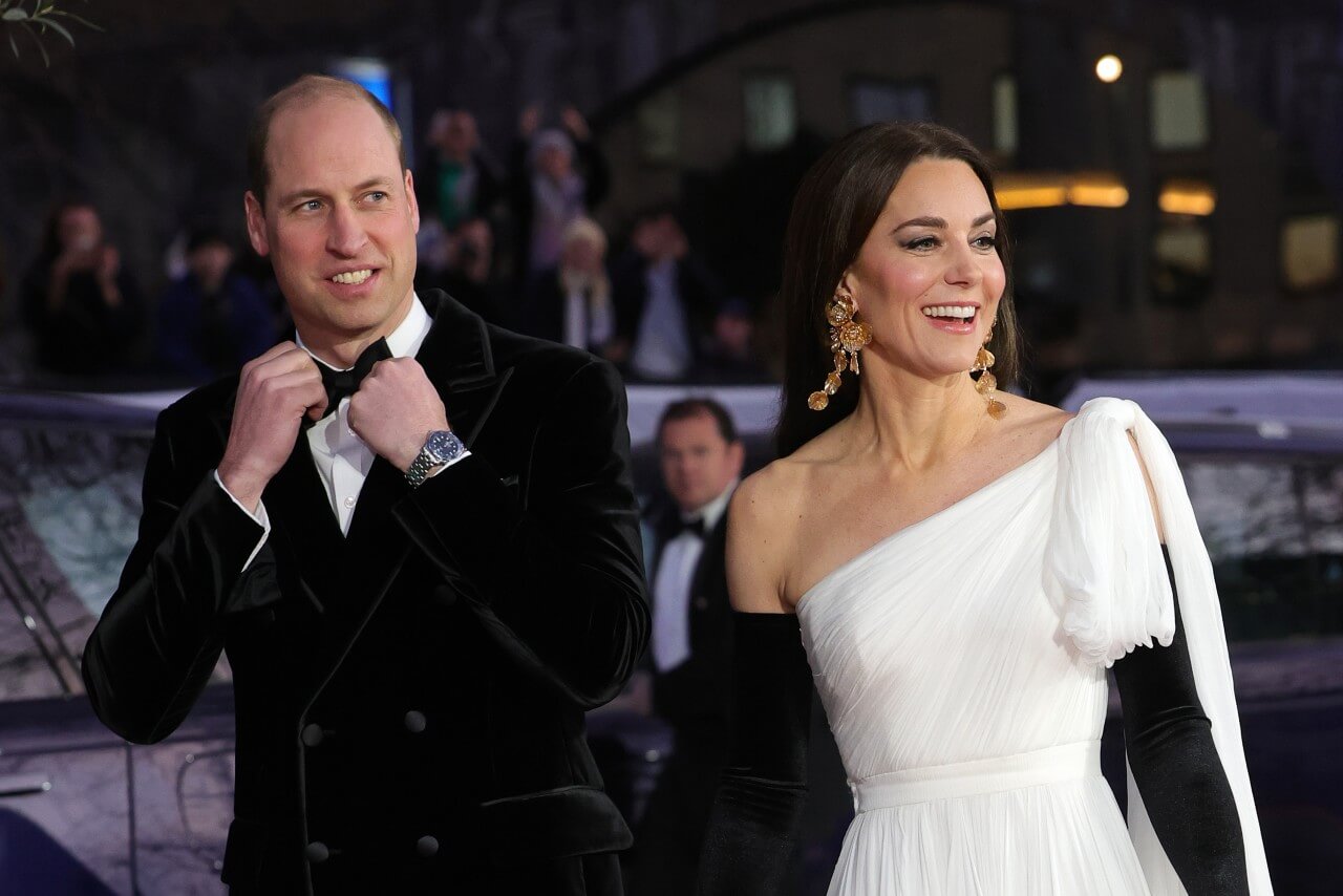Prince William adjusts his tie and Kate Middleton smiles during the 2023 BAFTAs.
