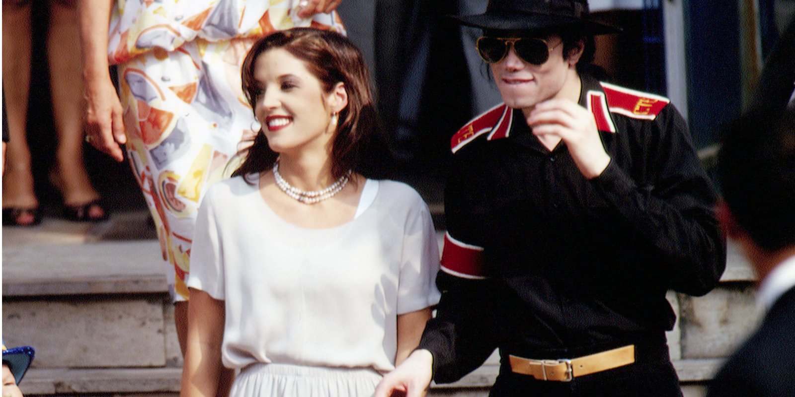 Lisa Marie Presley and Michael Jackson photographed together in front of a press pool.