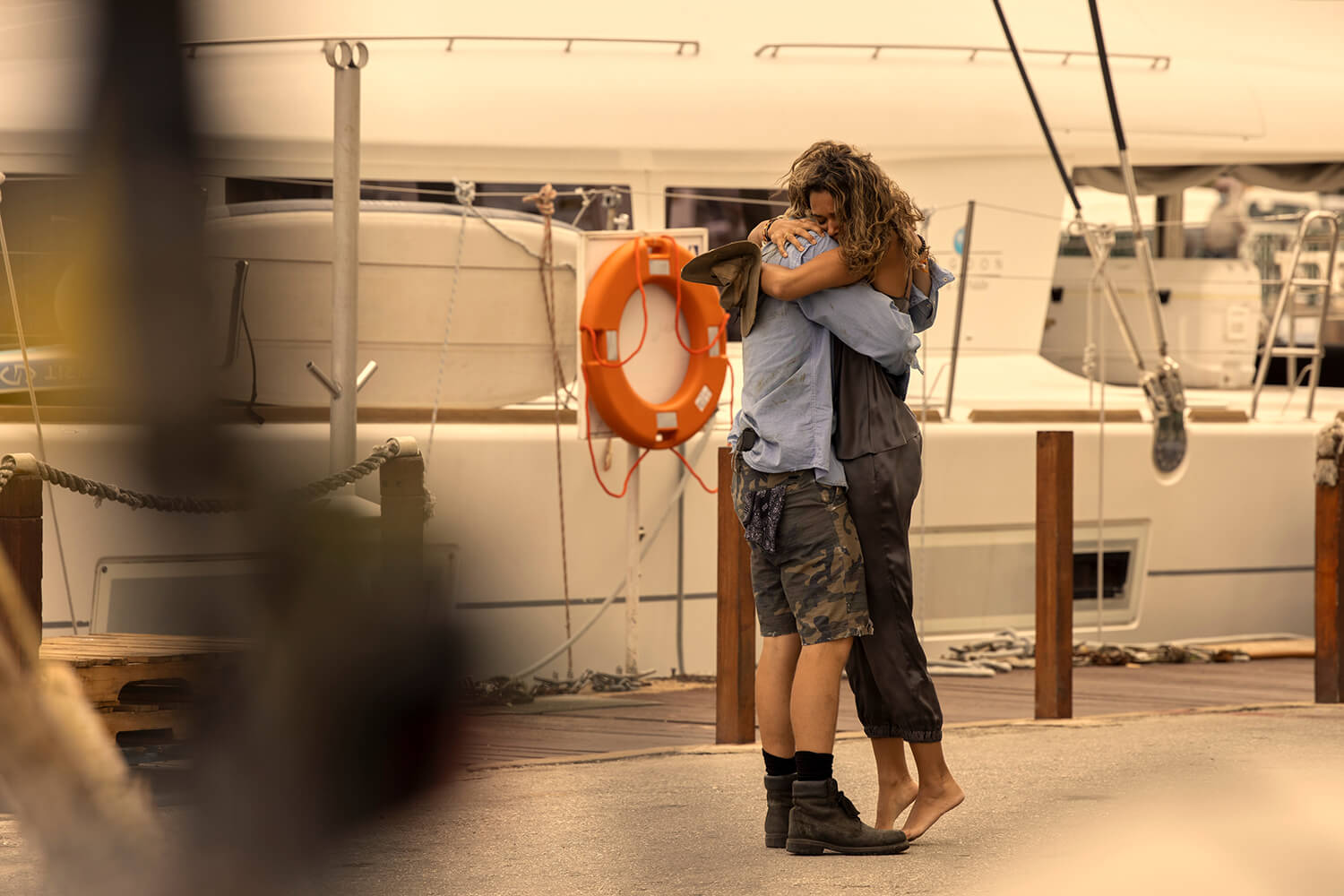 Outer Banks Season 3: Rudy Pankow as JJ and Madison Bailey as Kiara embracing in a hug on a dock.