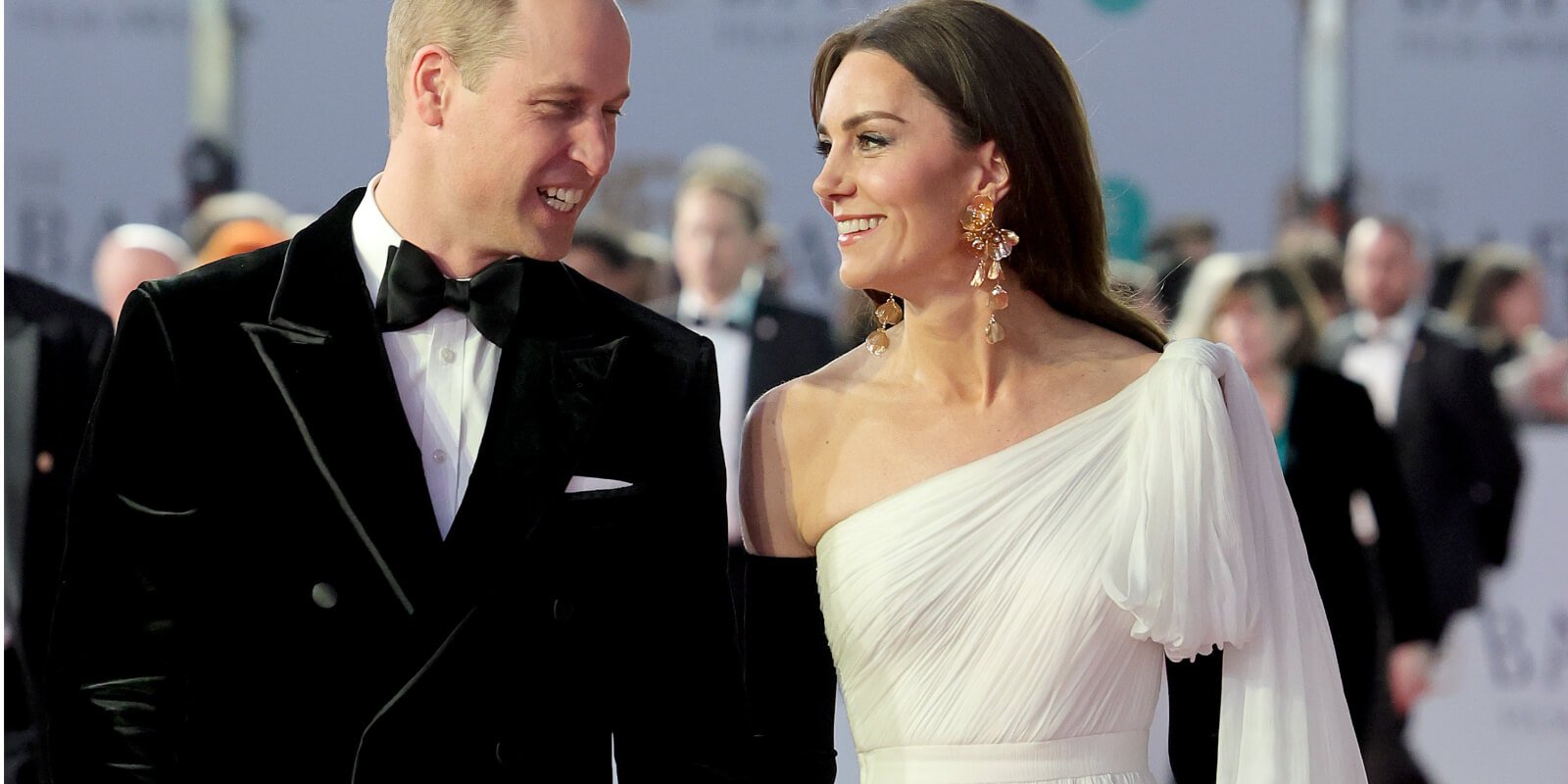 Prince William and Kate Middleton arrive on the BAFTAs red carpet where Kate playfully patted her husband's behind.