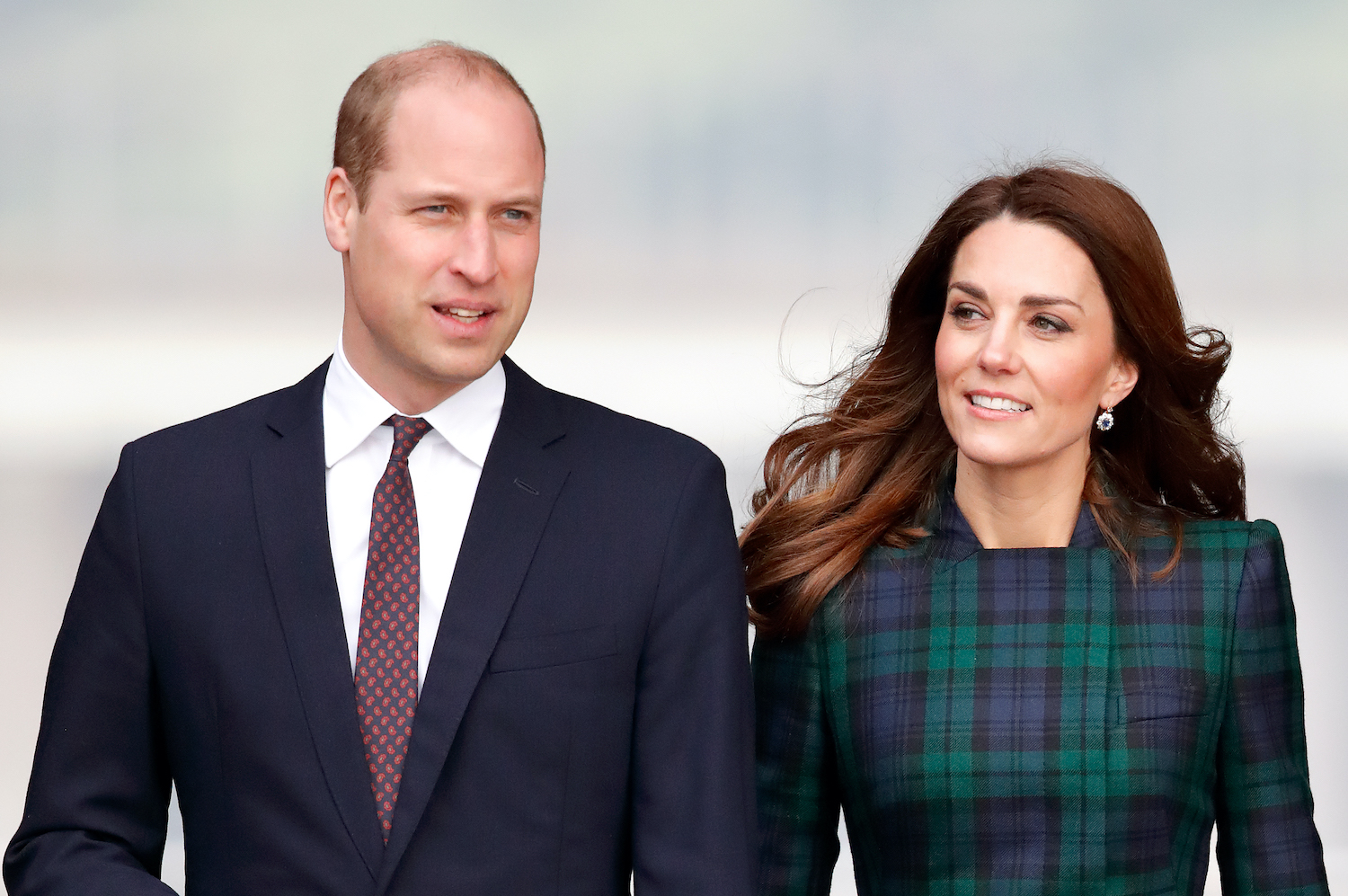 Prince William and Kate Middleton walk together smiling