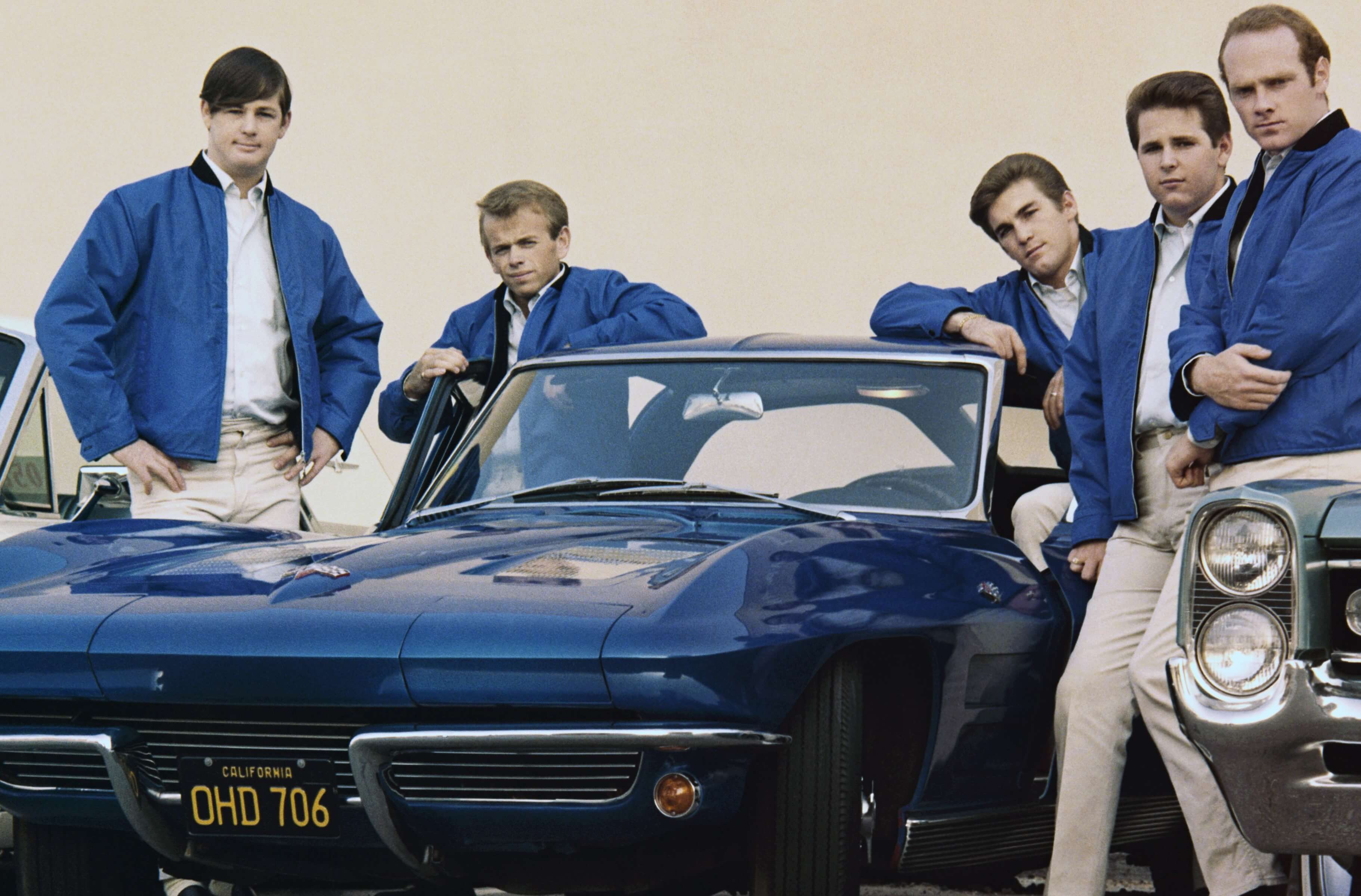 The Beach Boys near a car