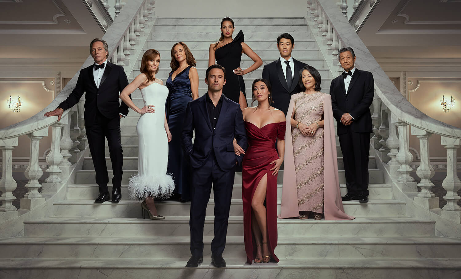 The Company You Keep cast: William Fichtner as Leo, Sarah Wayne Callies as Birdie, Polly Draper as Fran, Milo Ventimiglia as Charlie, Felisha Terrell as Daphne, Catherine Haena Kim as Emma, Tim Chiou as David Hill, Freda Foh Shen as Grace Hill, and James Saito as Joe Hill all posing together on a white staircase.