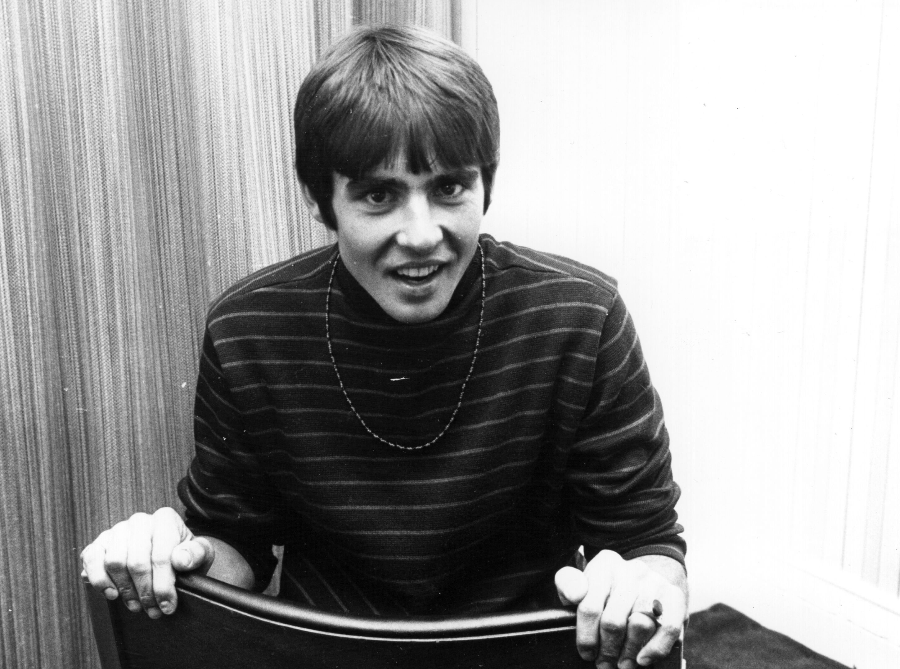 The Monkees' Davy Jones in a chair