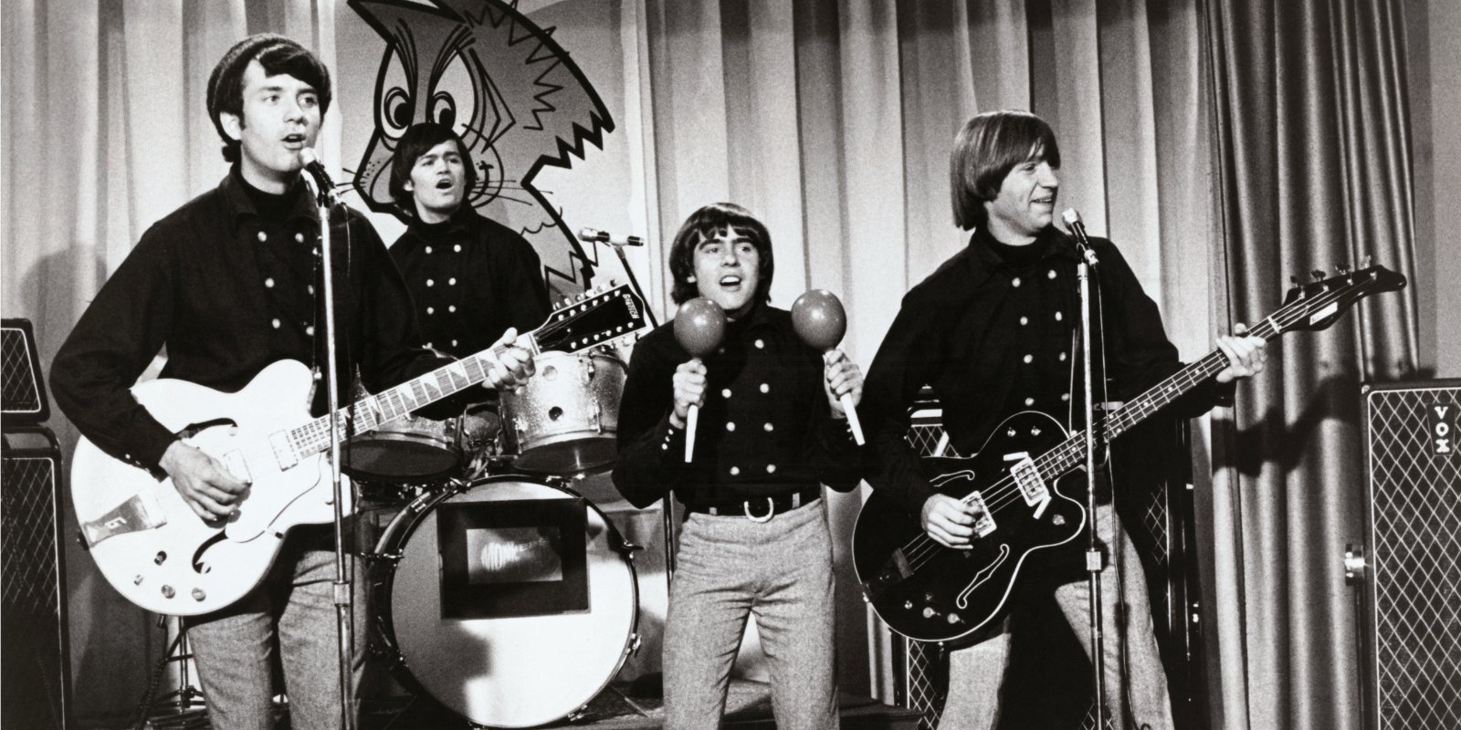 Mike Nesmith, Micky Dolenz, Davy Jones, and Peter Tork standing during The Monkees' taping.