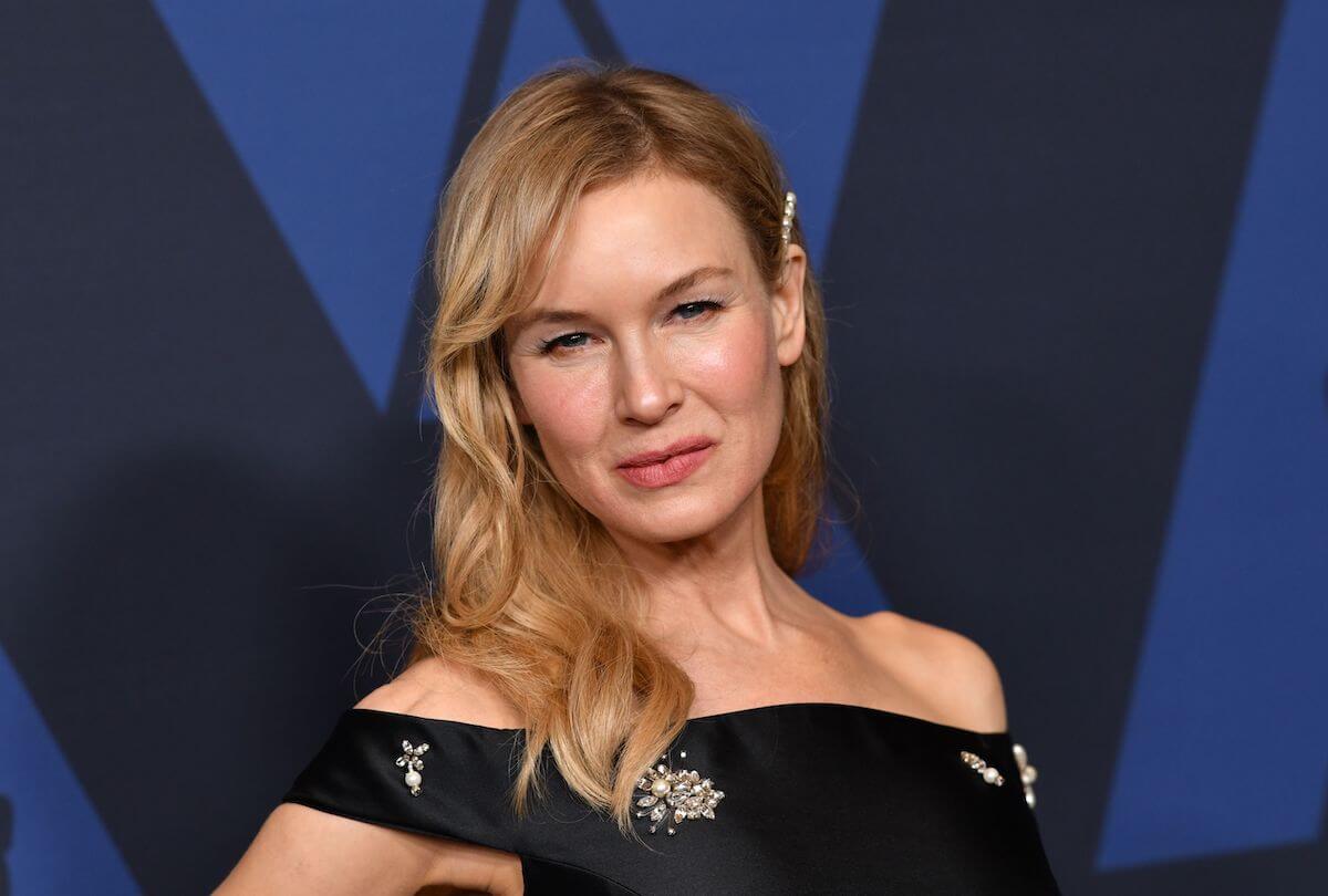 Renée Zellweger smiles and poses at an event.