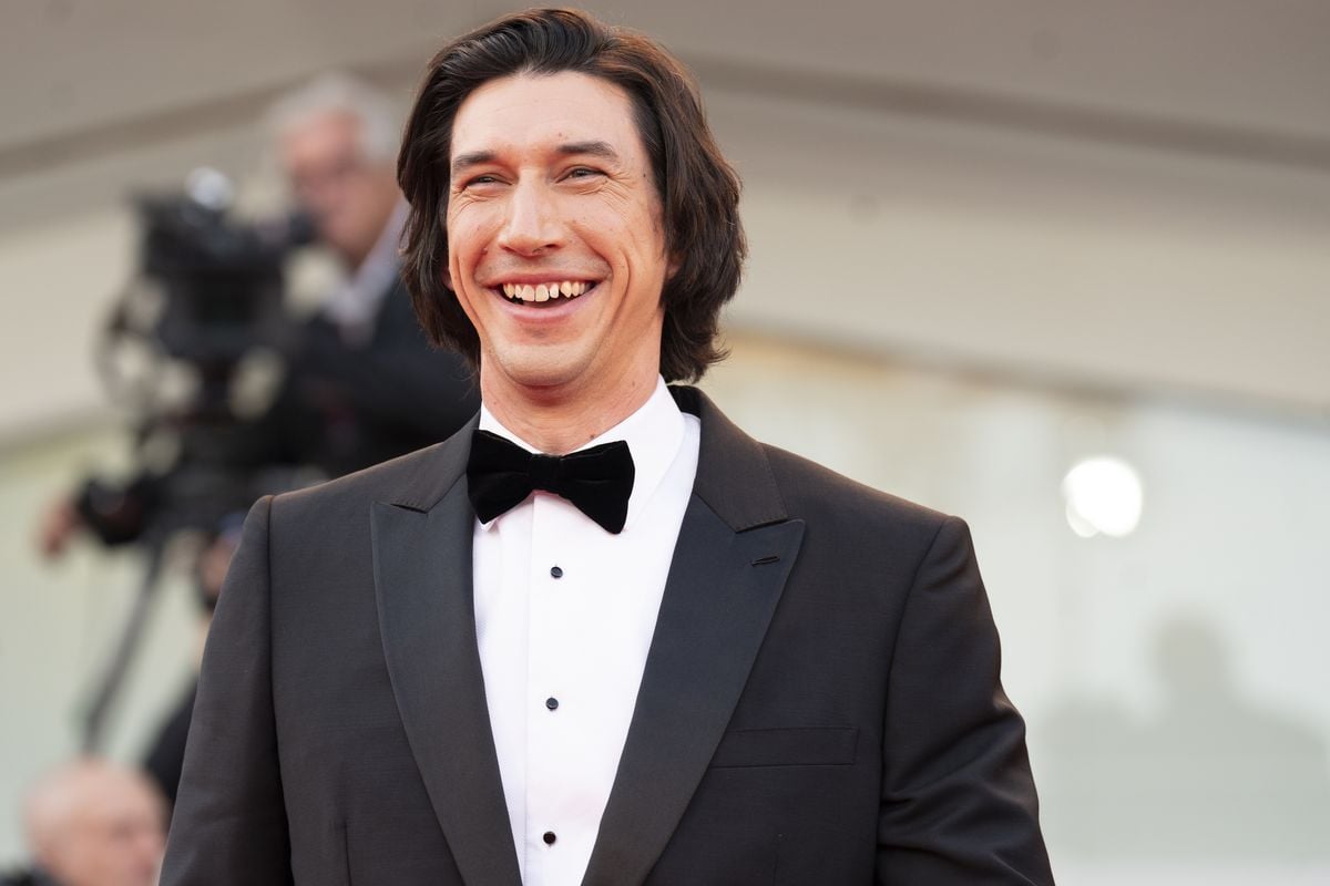 Adam Driver poses for photos at a red carpet event.