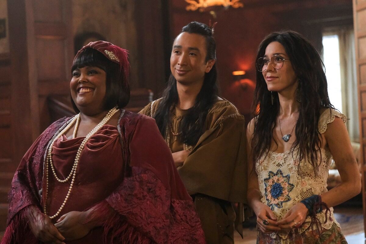Danielle Pinnock as Alberta, Roman Zaragoza as Sasappis and Sheila Carrasco as Flower stand together in an episode of 'Ghosts'