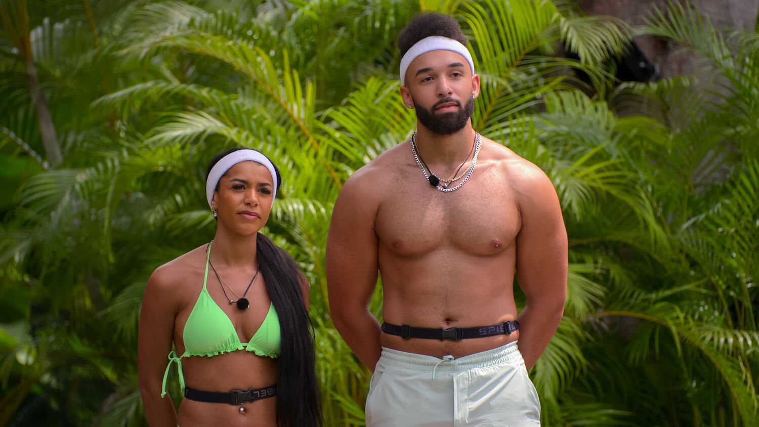 Are Bartise and Izzy still together? The couple stands here in front of some foliage in a production still from 'Perfect Match'