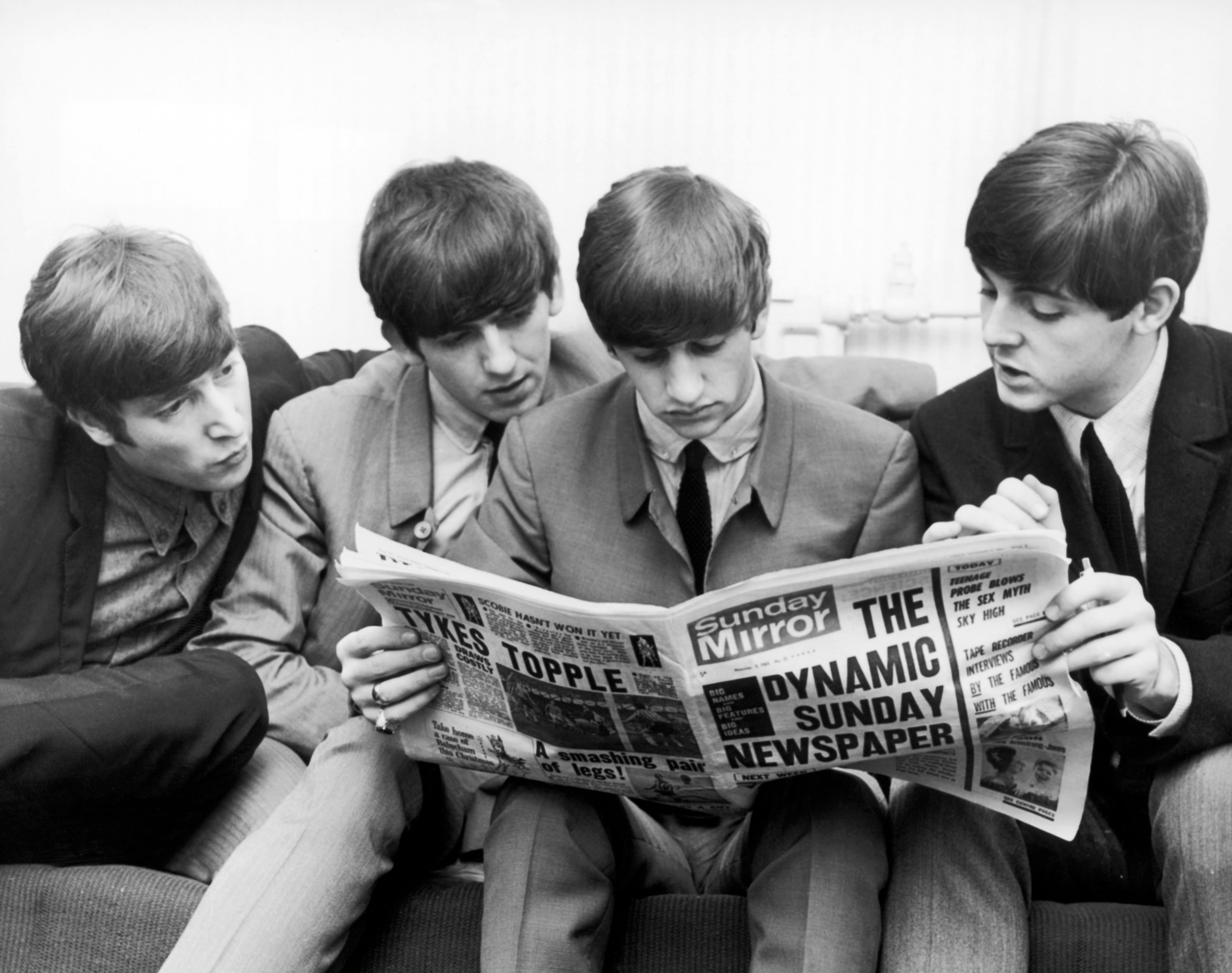 The Beatles read the newspaper ahead of their concerts at the Odeon, Leeds, in 1963