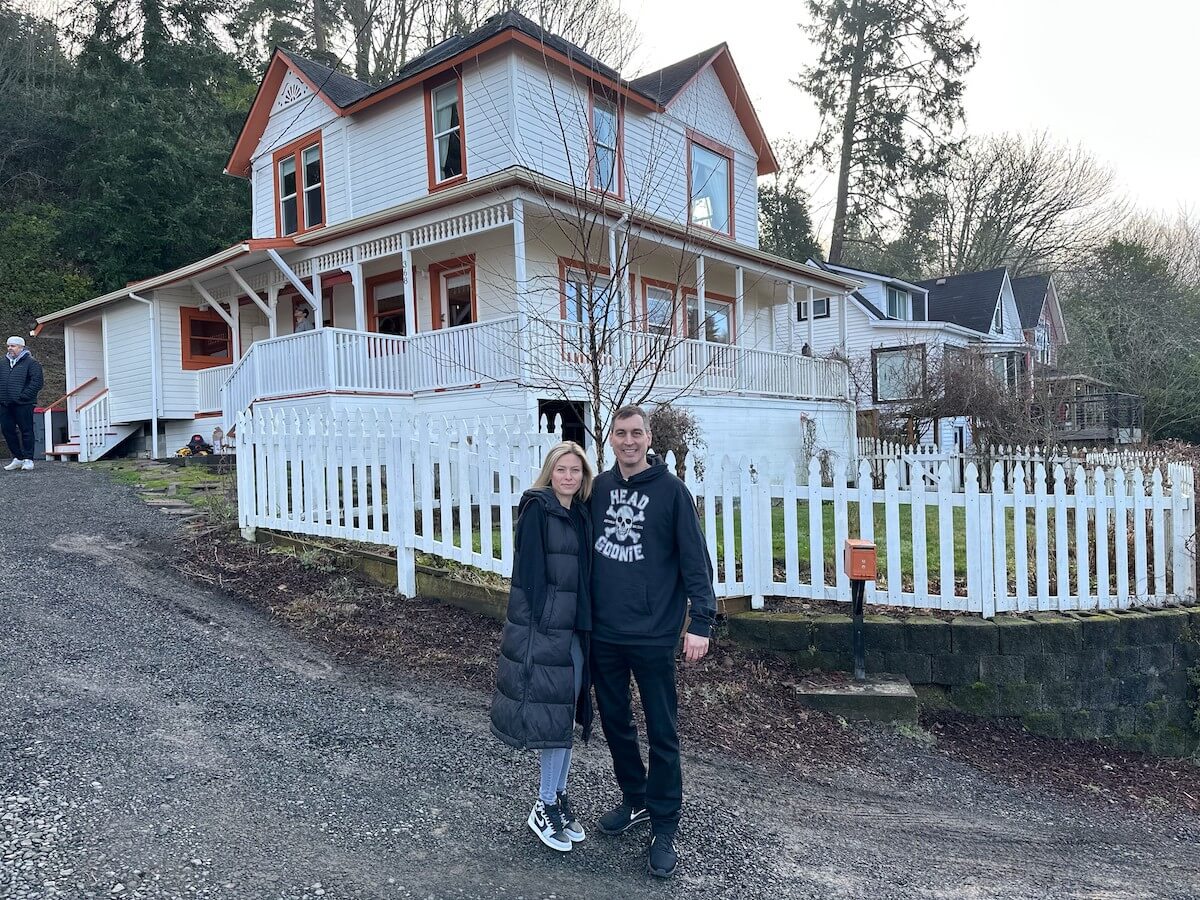 Behman Zakeri and his wife Liz pose in front of 'The Goonies' house