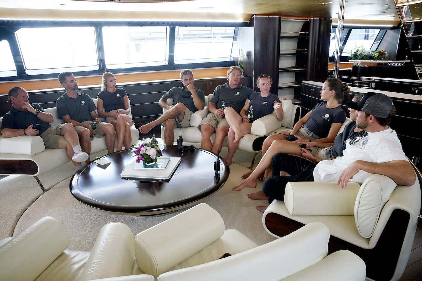 The 'Below Deck Sailing Yacht' crew sit on the white couch