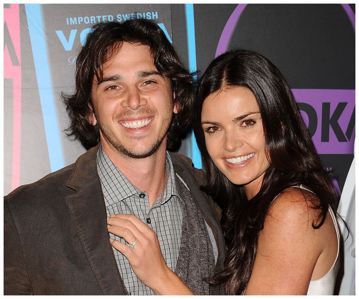 "The Bachelor" stars Ben Flajnik and Courtney Robertson smile and pose together at an event.