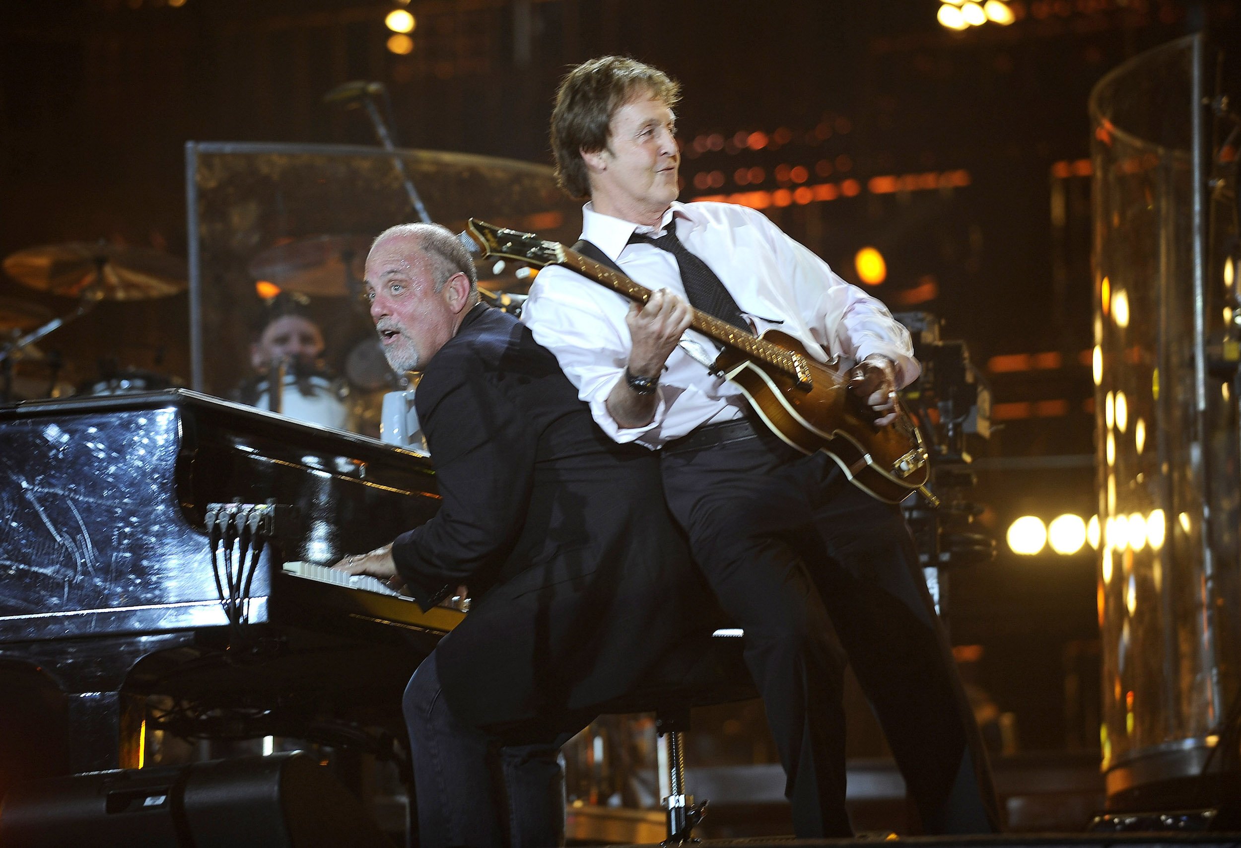 Billy Joel and Paul McCartney of The Beatles perform at Shea Stadium in Queens, NY