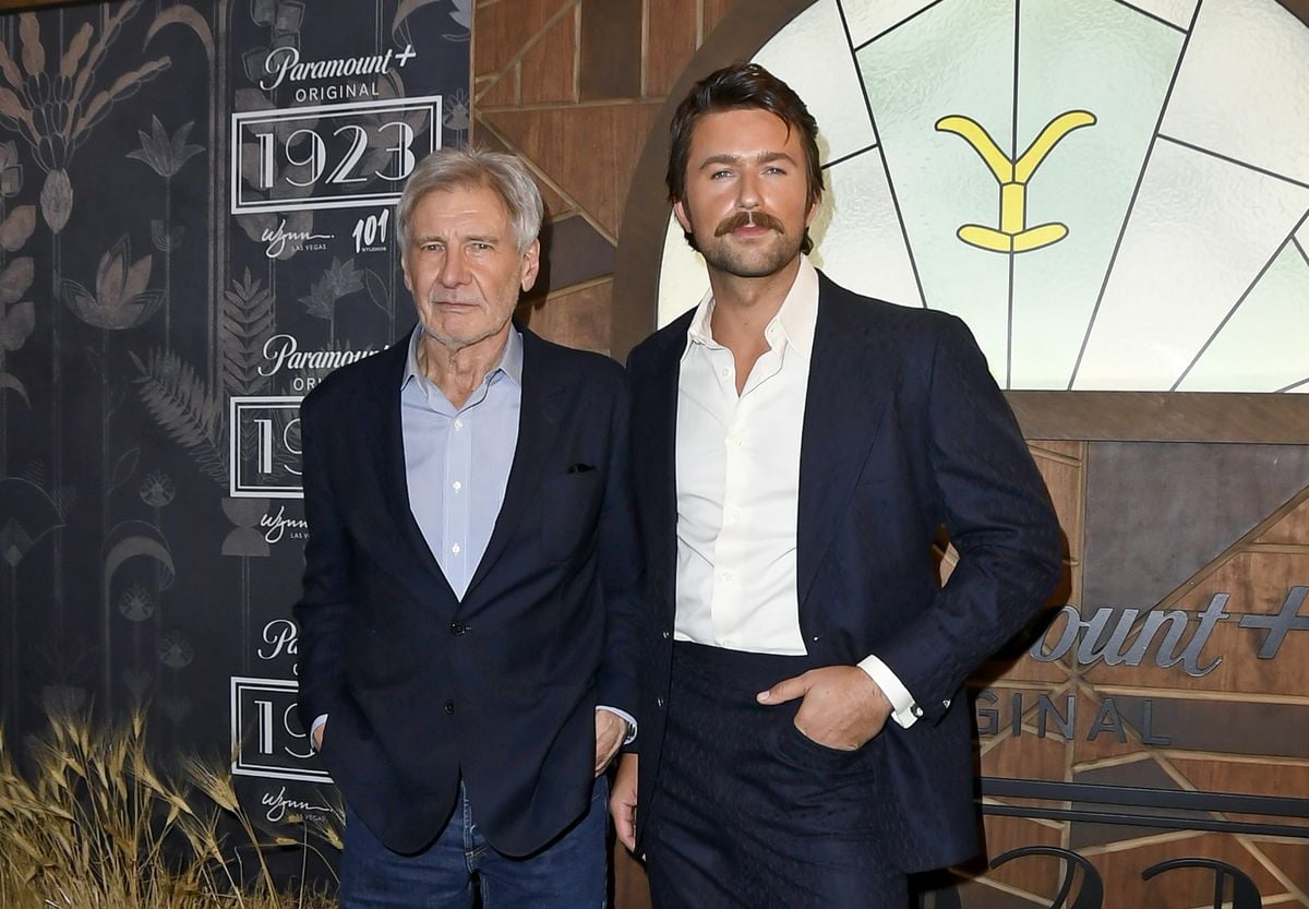 Harrison Ford and Brandon Sklenar pose at a "1923" premiere event.