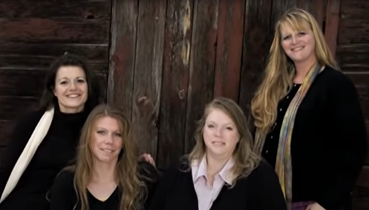 Robyn Brown and her sister wives pose for a promotional photo in black shirts early in the run of 'Sister Wives'. Robyn Brown was the last wife to marry Kody Brown