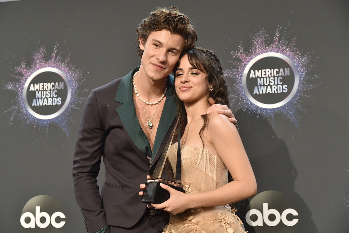 Shawn Mendes and Camila Cabello pose together at an awards show.