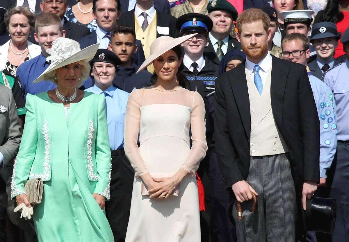 Camilla Parker Bowles, Meghan Markle, and Prince Harry pose for a photograph as they attend Charles' 70th Birthday Patronage Celebration