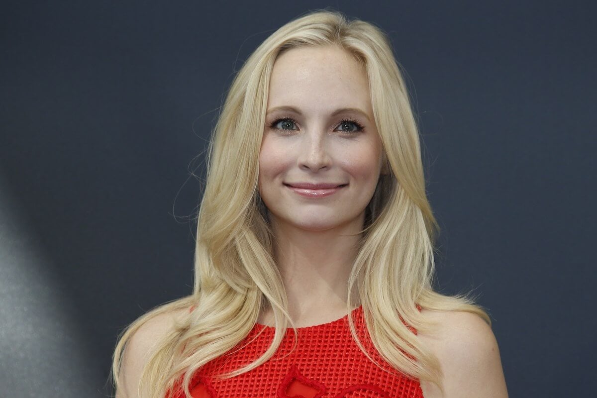 closeup of Candice King smiling wearing red