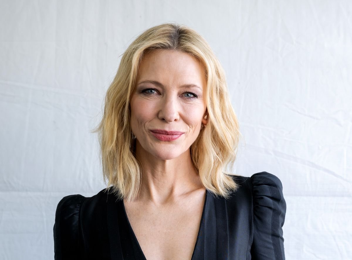 Cate Blanchett poses for a photo in front of a white backdrop.