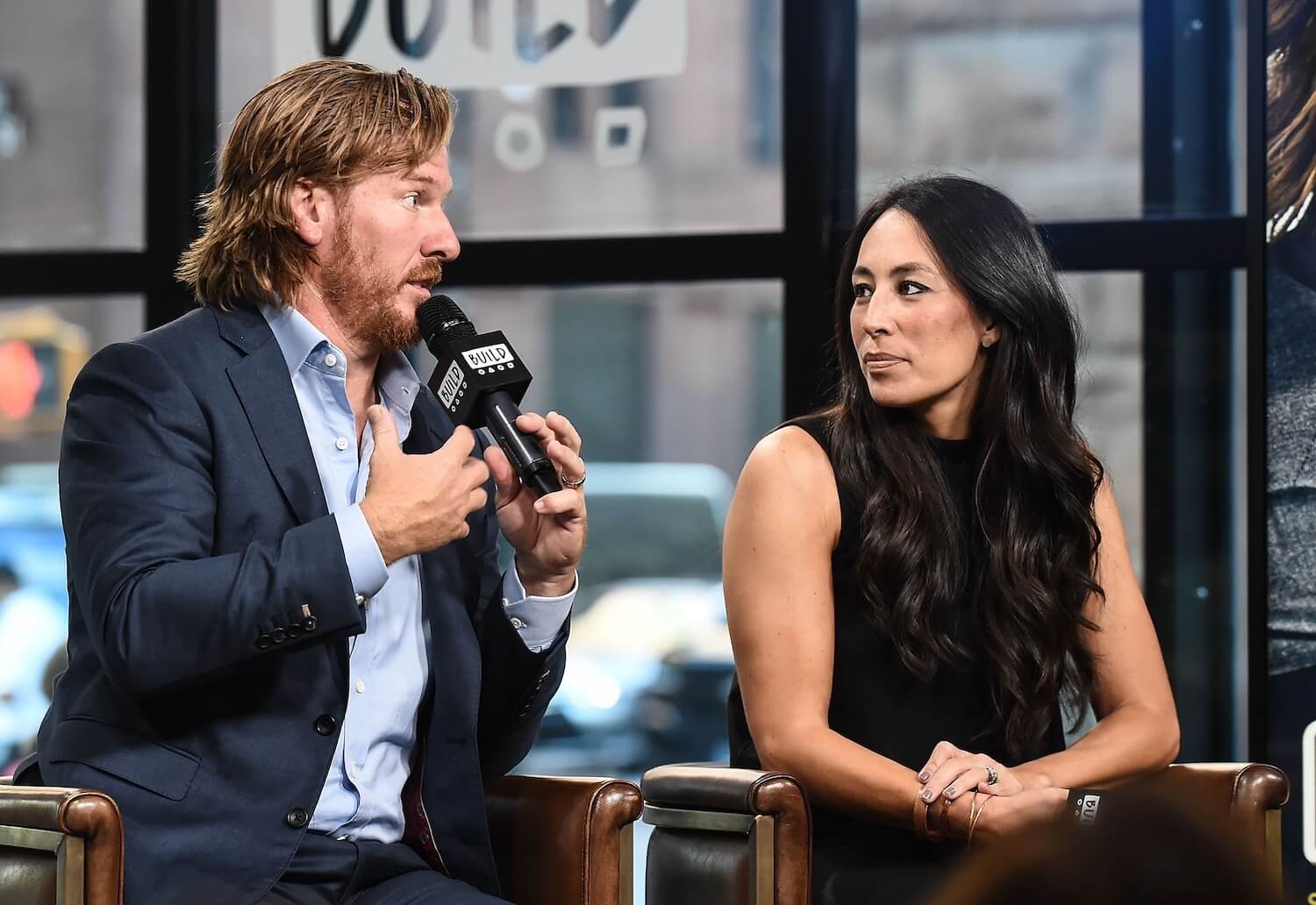 Chip Gaines and Joanna Gaines from 'Fixer Upper' sitting next to each other in an interview
