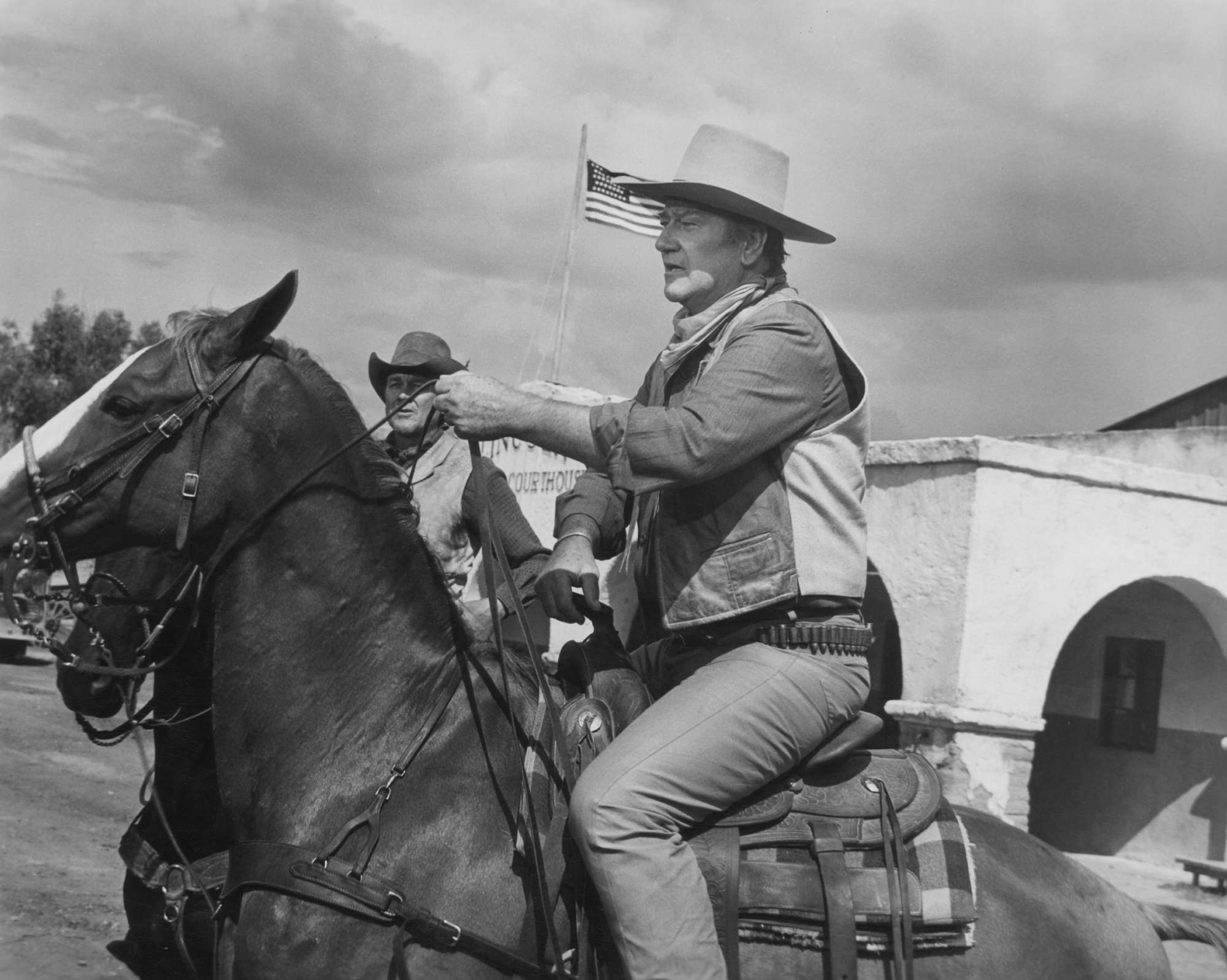 'Chisum' John Wayne as John Chisum riding a horse in a western costume