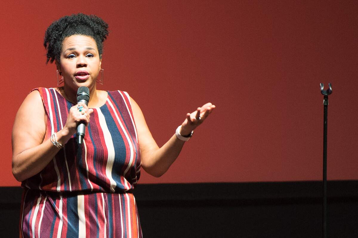 Desiree Burch does a standup comedy routine onstage in 2019