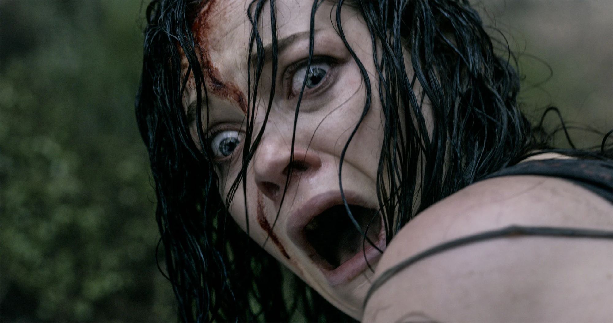 'Evil Dead' movies starring Jane Levy as Mia screaming, looking over her shoulder.