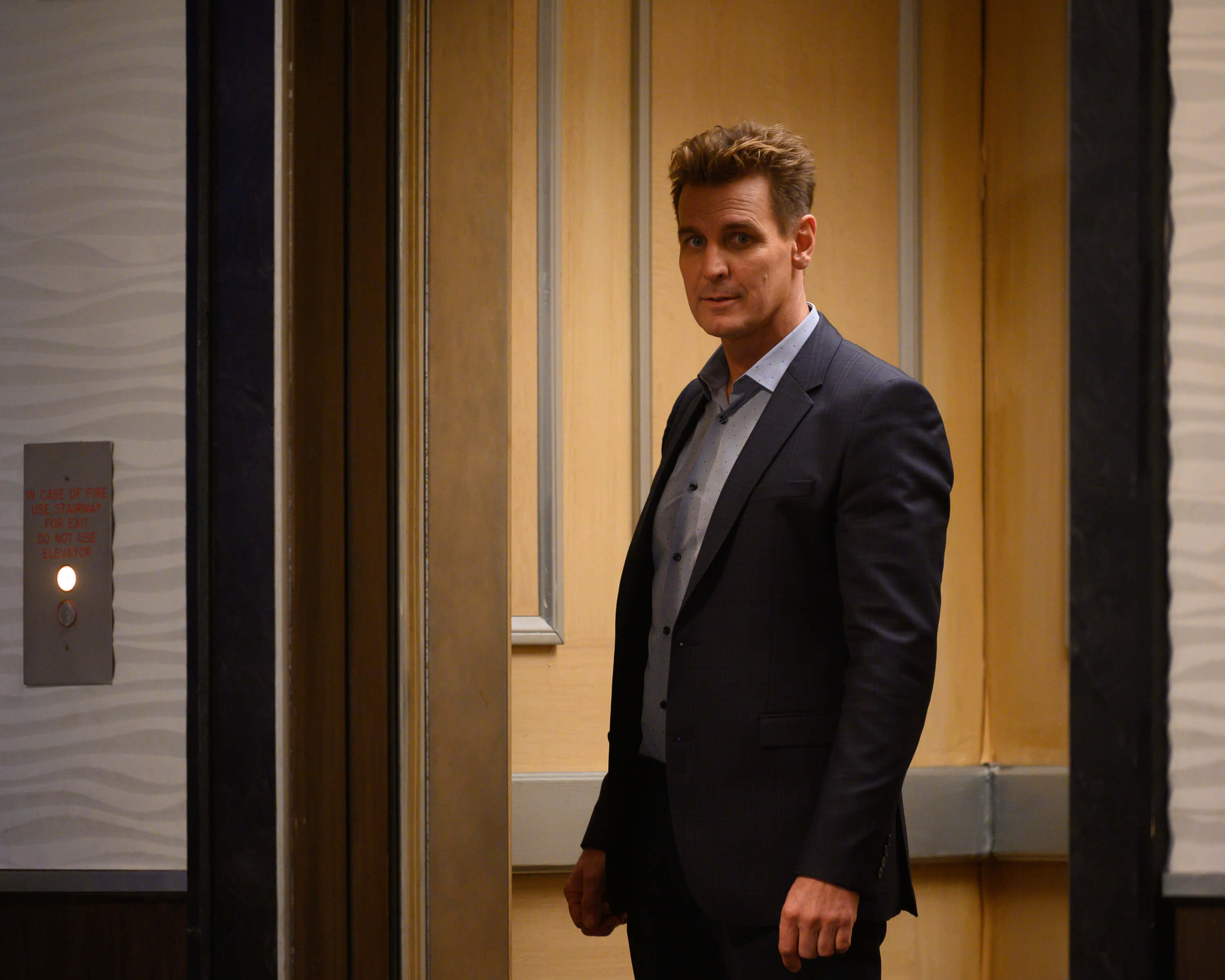 'General Hospital' star Ingo Rademacher dressed in a blue suit and shirt; in a scene from the soap opera.