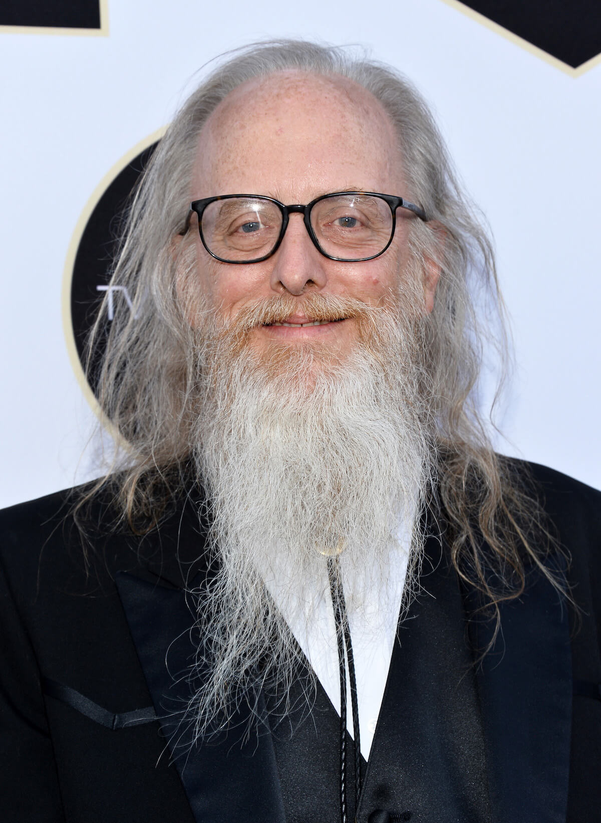 'Gilmore Girls' Second Troubadour David Gruber Allen smiles on a red carpet