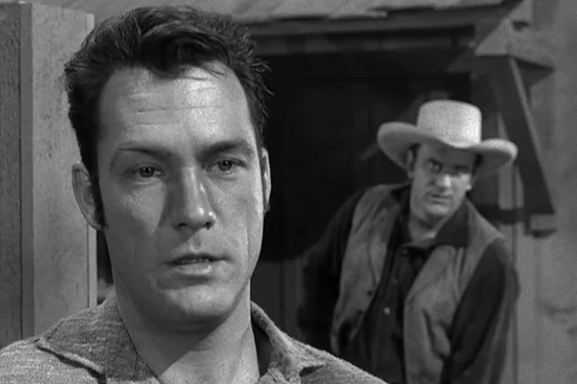 'Gunsmoke' Carl Betz as Nate Timble and James Arness as Matt Dillon. Arness is sneaking up behind him, while Betz is looking into the camera.