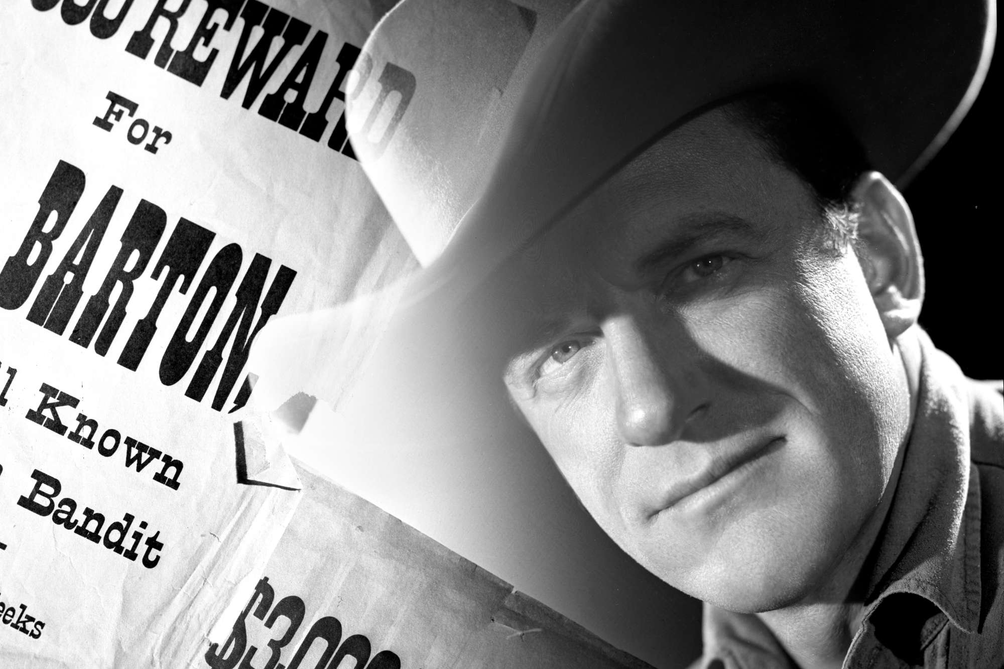 'Gunsmoke' James Arness as Matt Dillon wearing a cowboy hat with a wanted poster faded in the background.