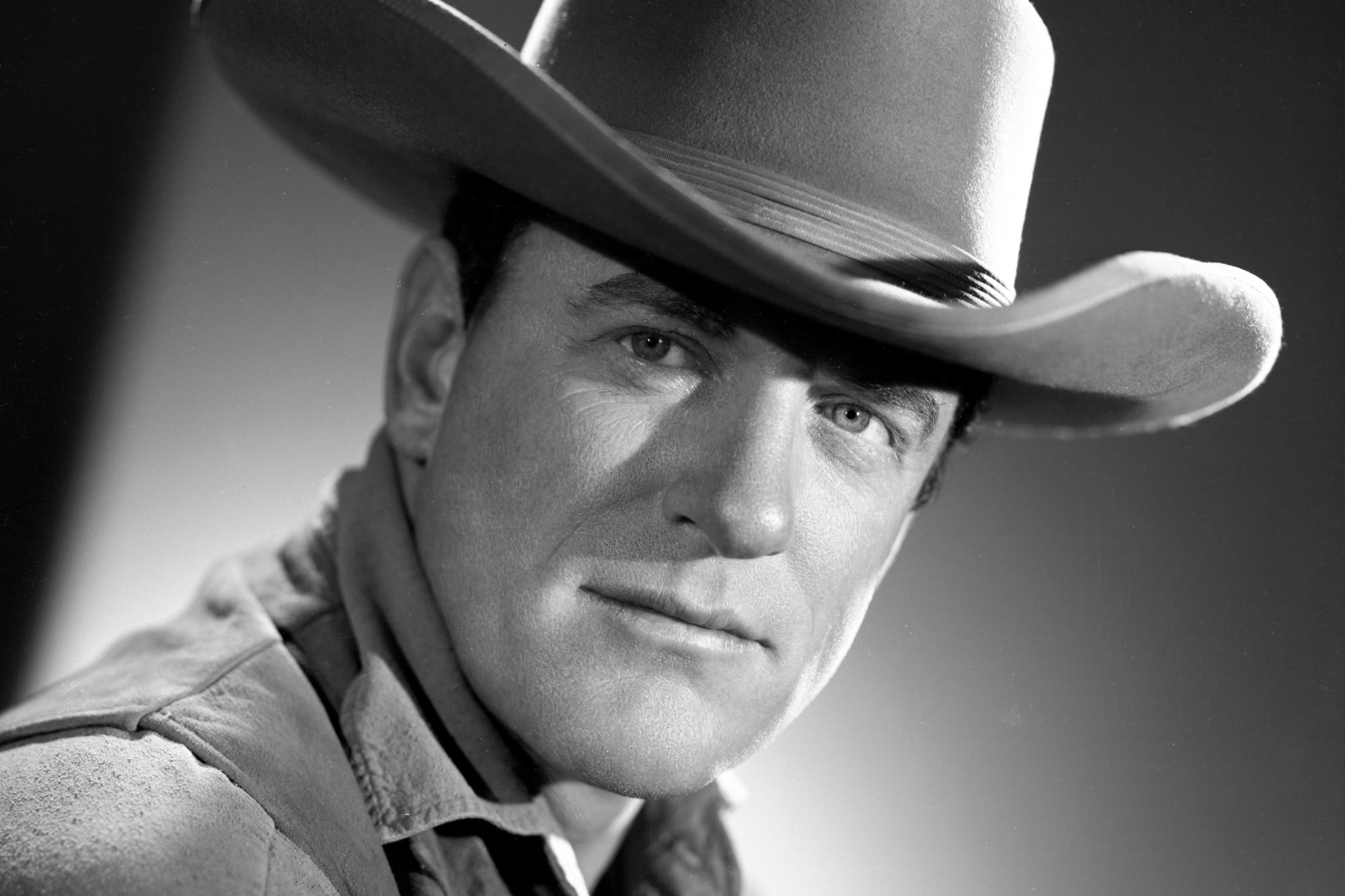 'Gunsmoke' James Arness as Matt Dillon in a black-and-white portrait photo wearing a cowboy hat.
