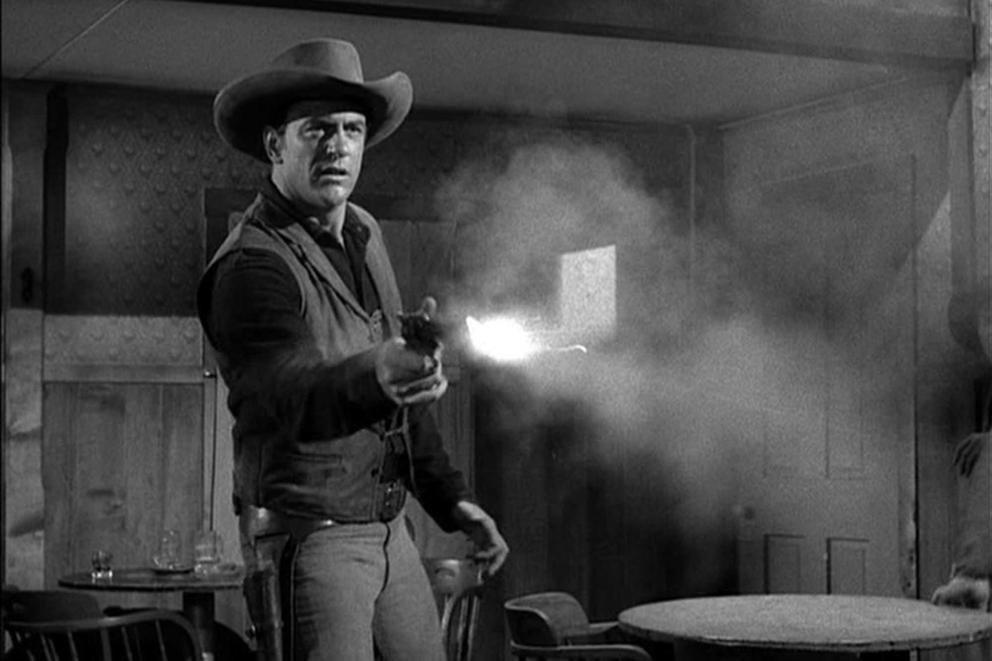 'Gunsmoke' James Arness as U.S. Marshal Matt Dillon shooting a pistol.