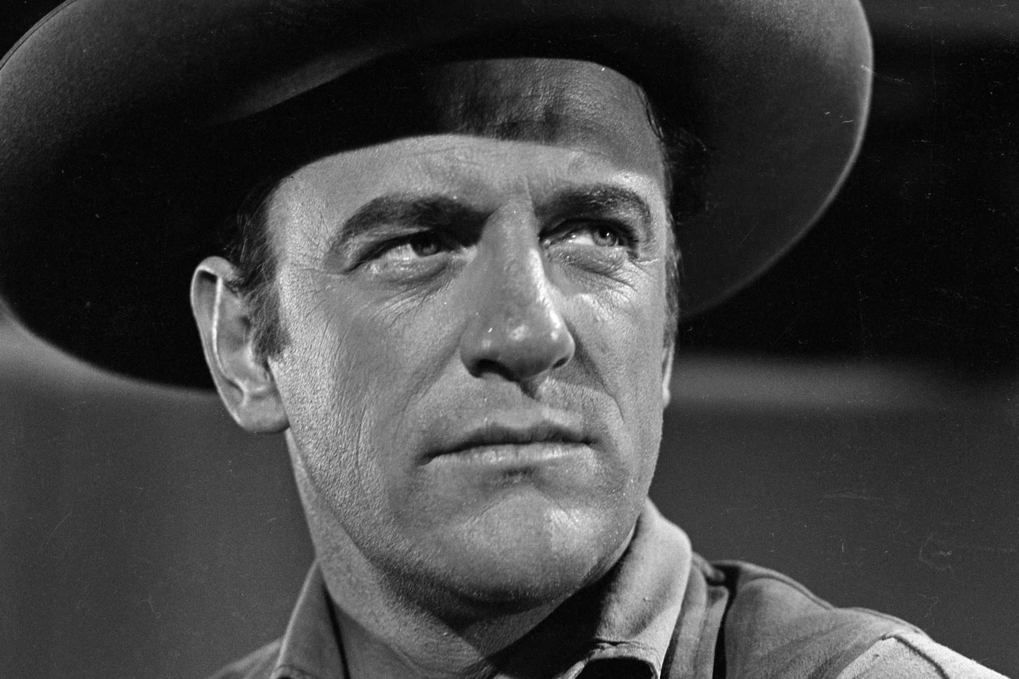 'Gunsmoke' James Arness as U.S. Marshal Matt Dillon looking up and to the side in a black-and-white picture.