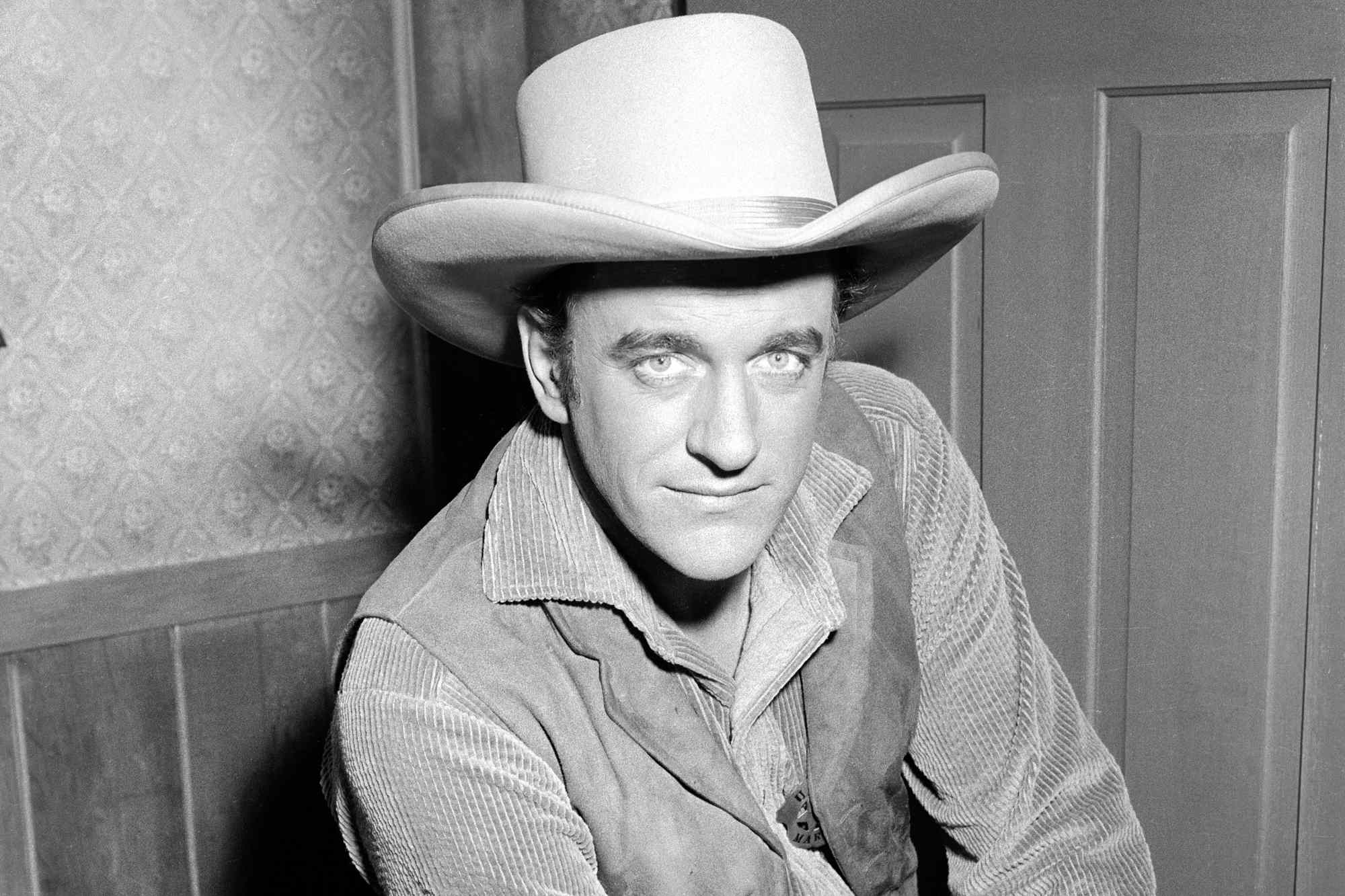 'Gunsmoke' episodes James Arness as Matt Dillon looking at the camera in a black-and-white picture, wearing a Western costume.