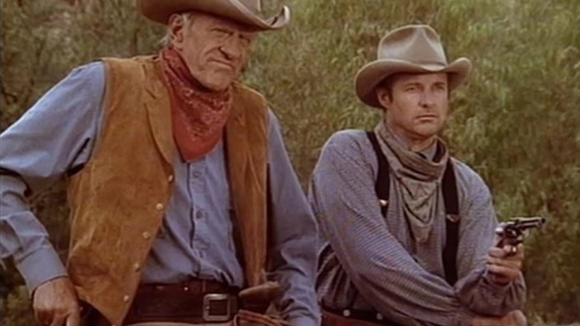 'Gunsmoke: One Man's Justice' James Arness as Matt Dillon and Bruce Boxleitner as Davis Healy. Matt has his hand on his pistol and Bruce is holding his pistol out.