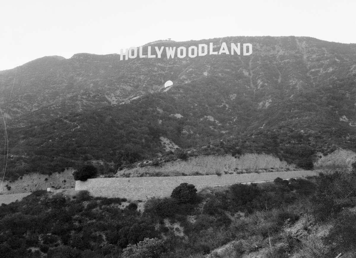 A black and white photo of the Hollywoodland sign in 1932