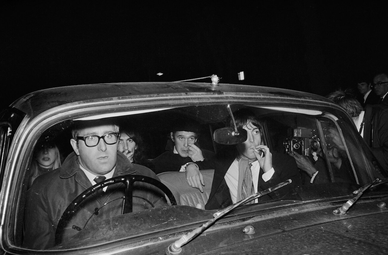 Mal Evans, Pattie Boyd, George Harrison, Neil Aspinall, and Paul McCartney in a car in 1967.
