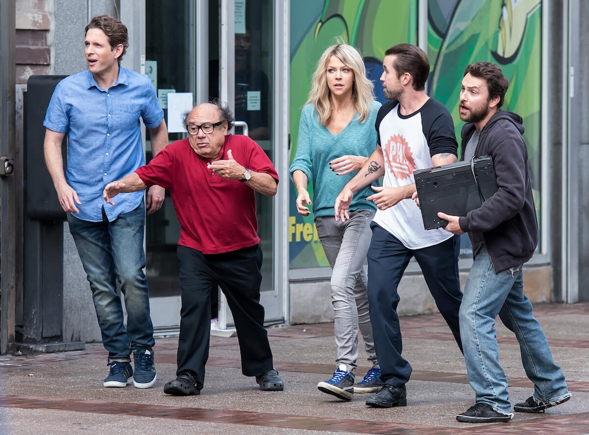 The cast of 'It's Always Sunny in Philadelphia' standing together filming a scene