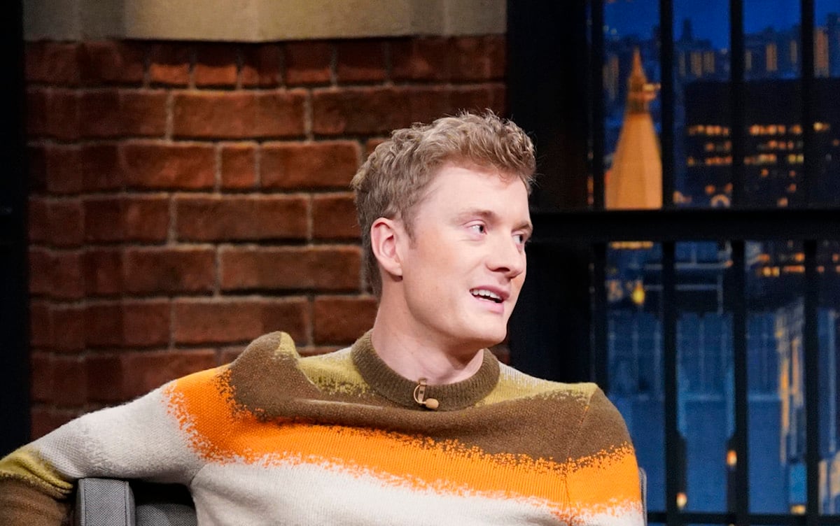 Stand-up comedian James Acaster wearing a striped sweater