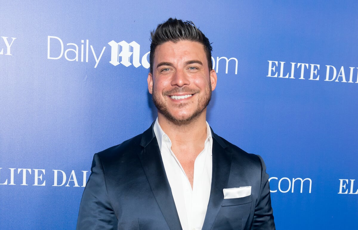 Jax Taylor in a suit in front of a blue background