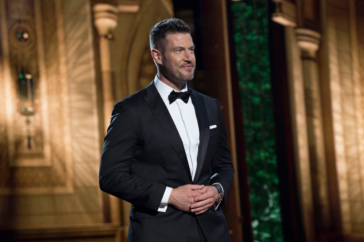 Jesse Palmer standing in a tux with his arms clasped