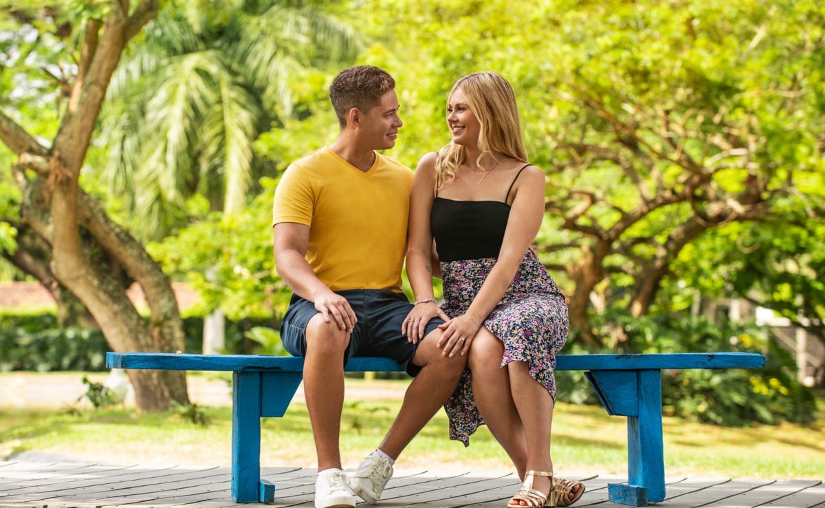Jessica and Juan sitting on a bench together for '90 Day Fiancé: Love in Paradise' Season 3 promo on TLC.