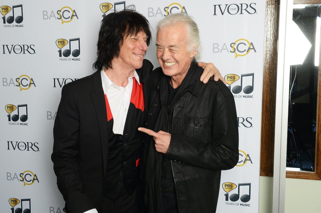 Jimmy Page (right) points toward Jeff Beck as they both wear black at the 2014 Novello Awards ceremony in London.