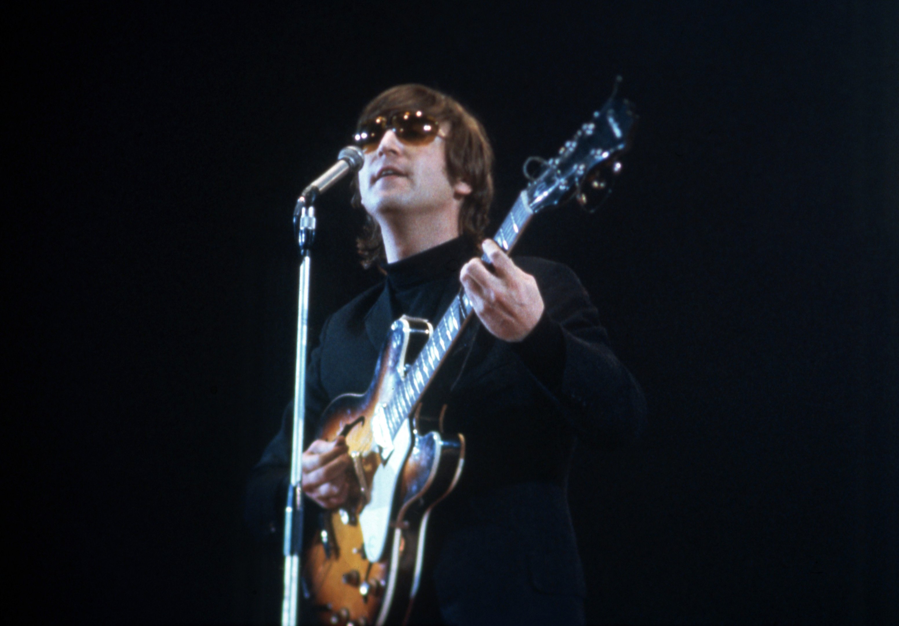 John Lennon of The Beatles performs at the NME Awards