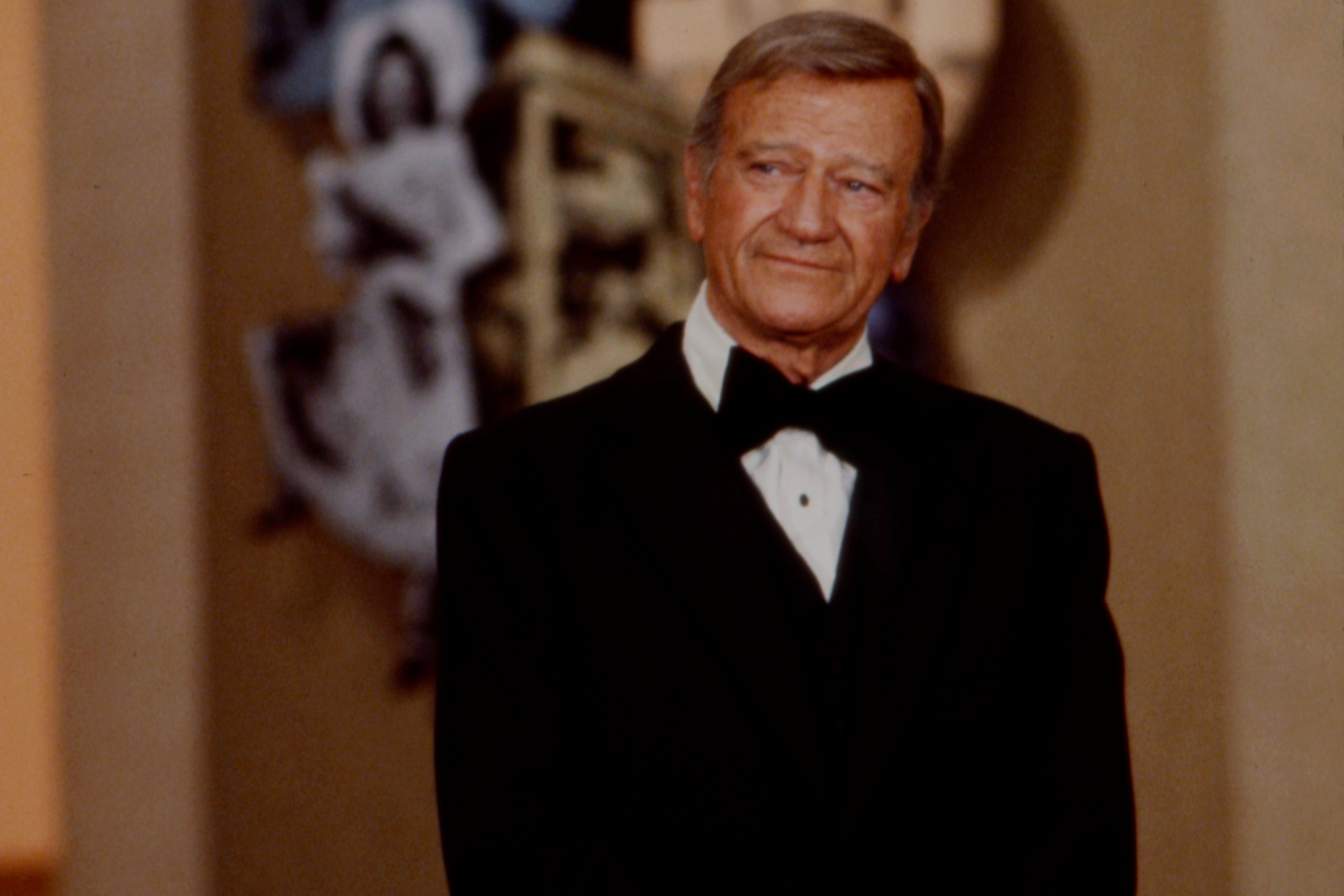 John Wayne, who died from cancer. He's wearing a tux, looking to the side.