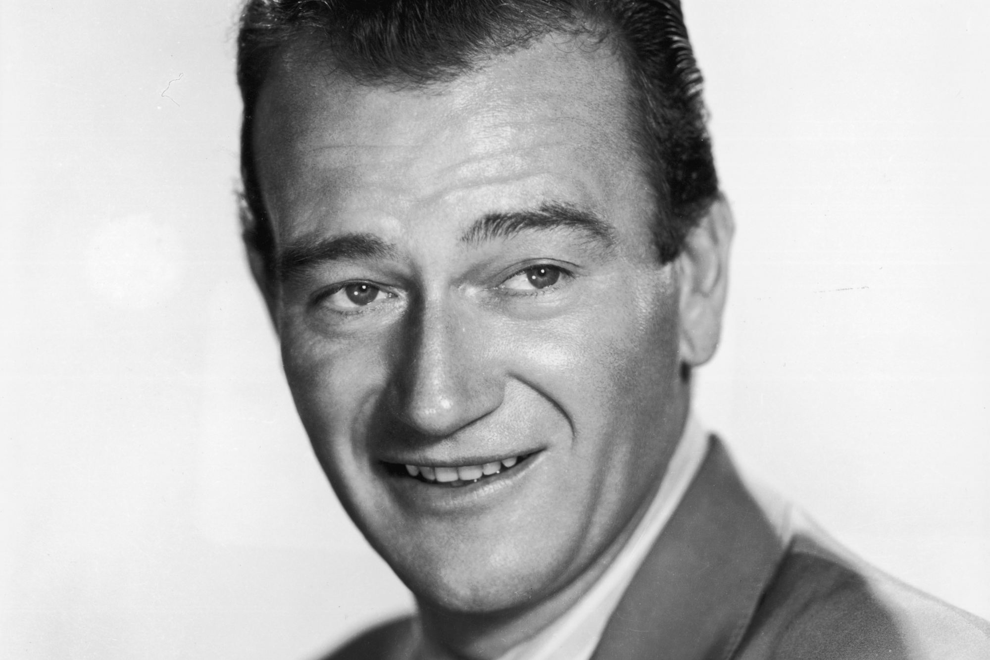 John Wayne, whose yearbook was on 'Pawn Stars.' He's smiling in a black-and-white portrait image, looking to the side.