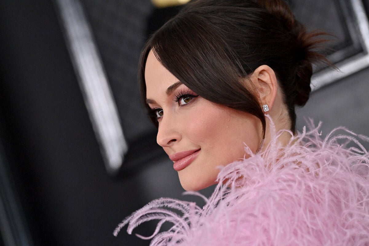 Kacey Musgraves looking over her shoulder and smiling