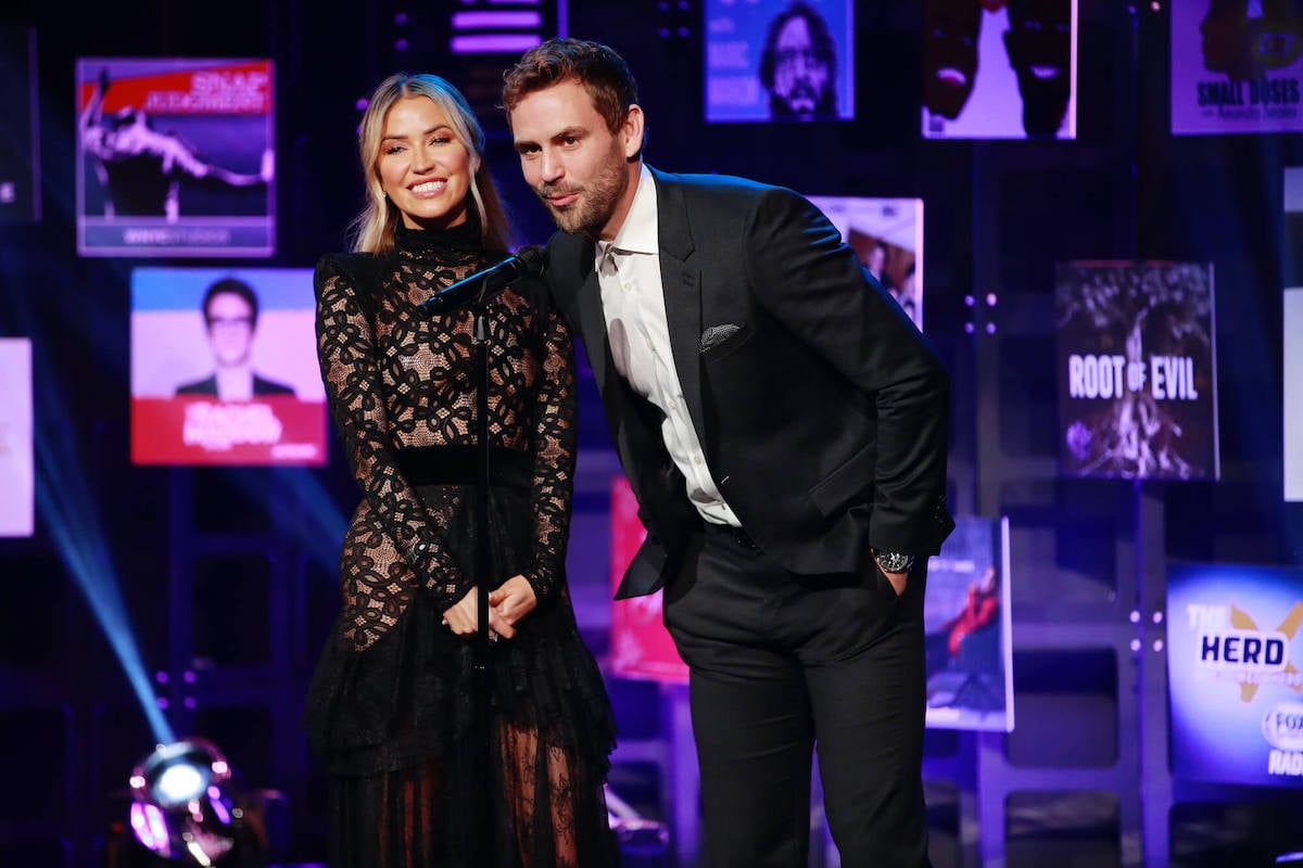 Kaitlyn Bristowe and Nick Viall smiling, standing at a microphone